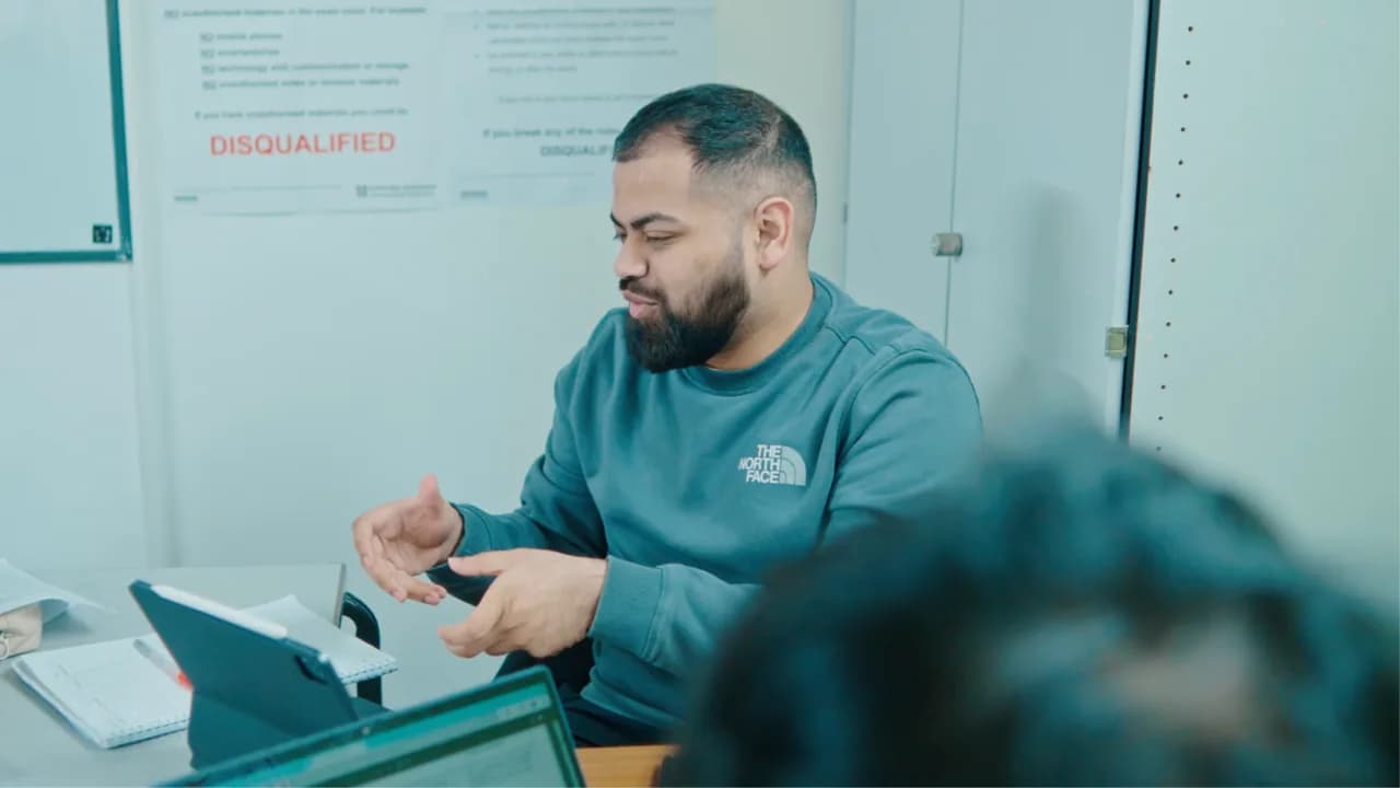 A coding specialist helping a young learner at Excel Tutors